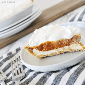 A slice of Pumpkin Pie Cheesecake on a white plate