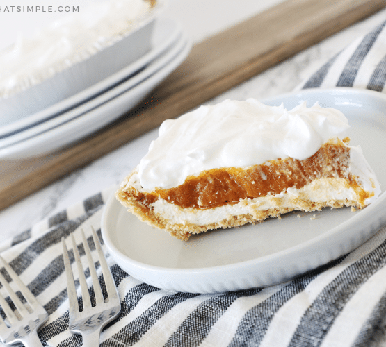 A slice of Pumpkin Pie Cheesecake on a white plate