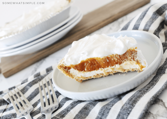 A slice of Pumpkin Pie Cheesecake on a white plate
