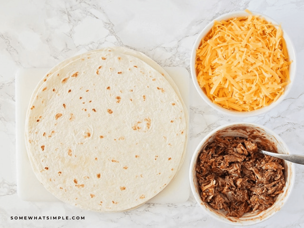 BBQ Pork Quesadillas ingredients laid on a white counter