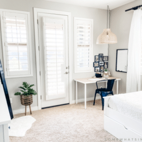 Modern boho bedroom with standing mirror, desk, dresser and twin bed