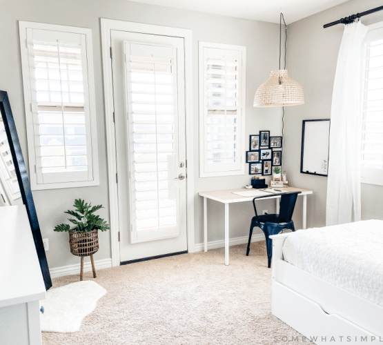 Modern boho bedroom with standing mirror, desk, dresser and twin bed