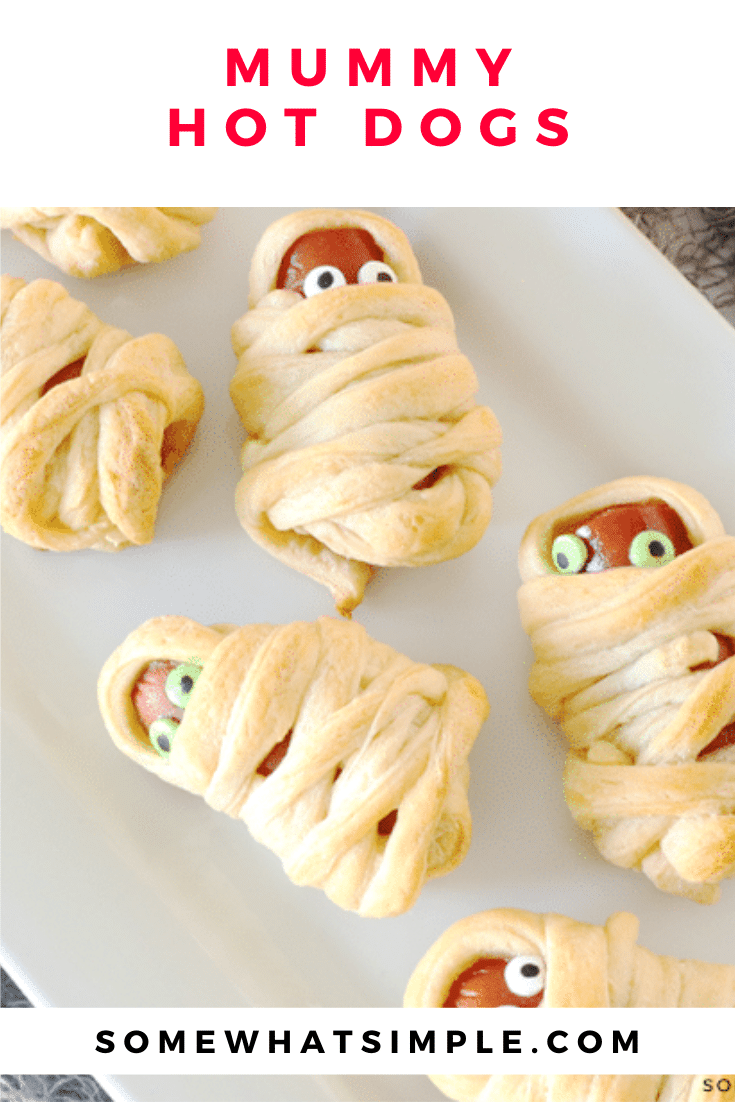 Mummy Hot Dogs are a hit with kids and Halloween party guests! They're a festive Halloween treat that's simple to make and delicious too! They're super easy to make by wrapping hot dogs in some crescent roll dough. They make the perfect Halloween snack or lunch recipe. via @somewhatsimple