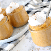 small cups of pumpkin pudding with whipped cream