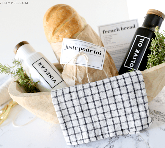gift basket with bread, olive oil and vinegar bottles