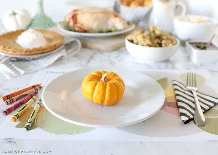 simple thanksgiving place setting with printable placemat and food in the background