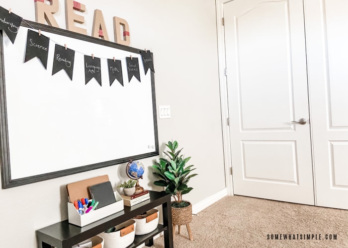 front view of a homeschool room with a white board and bookshelf