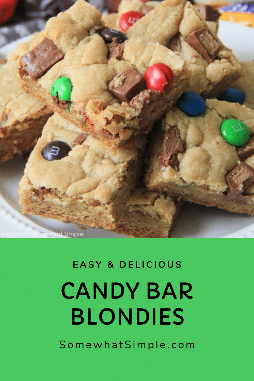 Candy Bar Blondies are a fun twist on a favorite dessert. The deliciously chewy brownie dough gets stuffed and topped with your favorite candies. It's a simple, sweet, and chocolatey treat! via @somewhatsimple