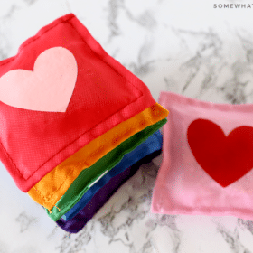 stack of rainbow bean bags with hearts in the center