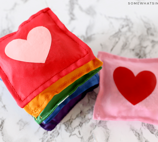 stack of rainbow bean bags with hearts in the center