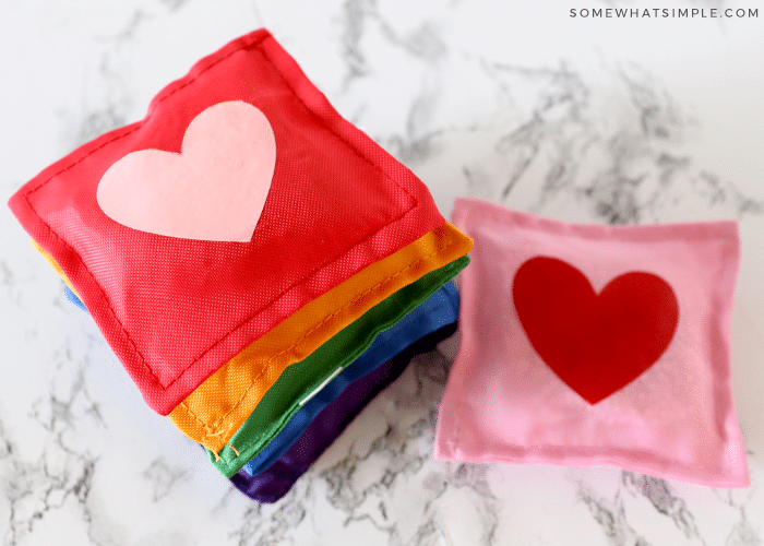 stack of rainbow bean bags with hearts in the center