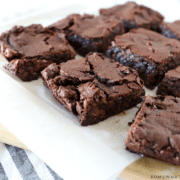 9 brownies sitting on parchment paper