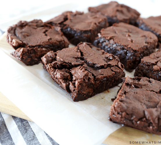9 brownies sitting on parchment paper