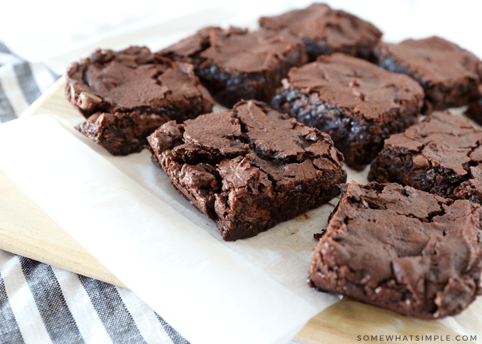9 brownies sitting on parchment paper