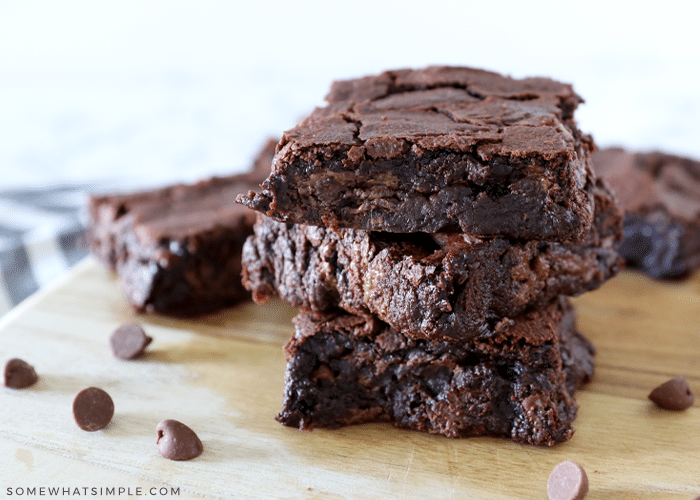 stack of vegan brownies on a brown cutting board