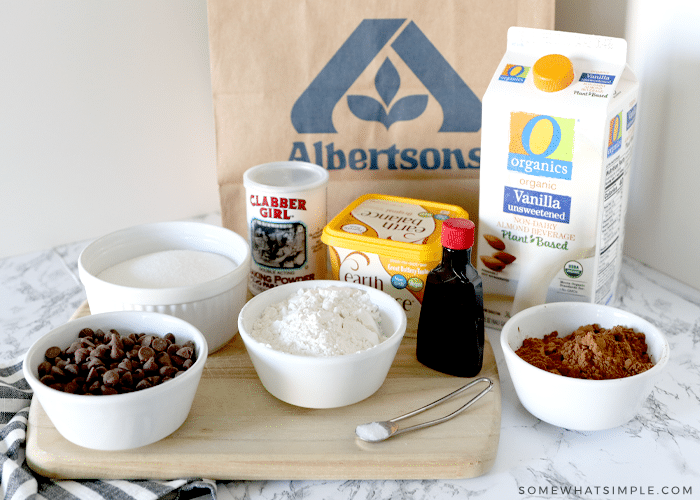 ingredients to make vegan brownies on a counter with a paper grocery bag in the background!