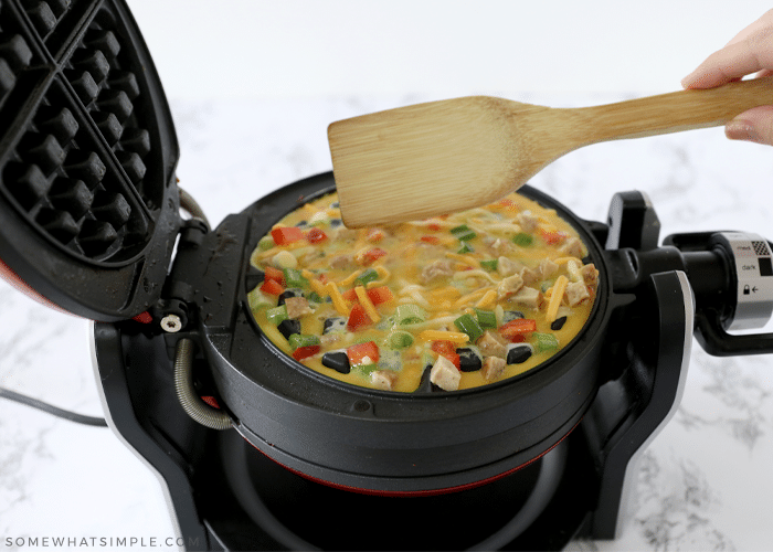 omelet being cooked in a waffle iron 