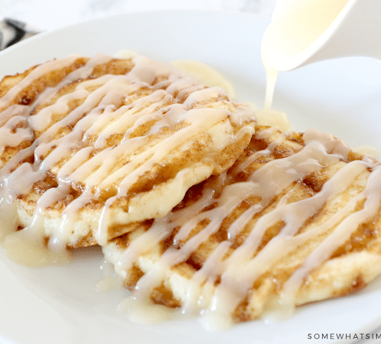 drizzling glaze over cinnamon roll pancakes