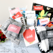 a date night basket with various items for a cozy indoor date - blankets, snacks, hot cocoa, etc.
