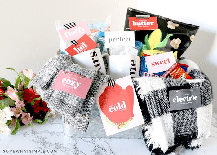 a date night basket with various items for a cozy indoor date - blankets, snacks, hot cocoa, etc.