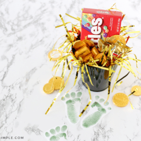 paper leprechaun footprints leading to a pot of candy