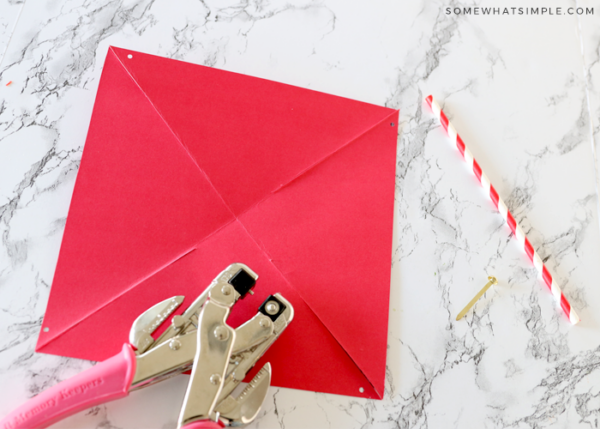 hole punch on top of red paper