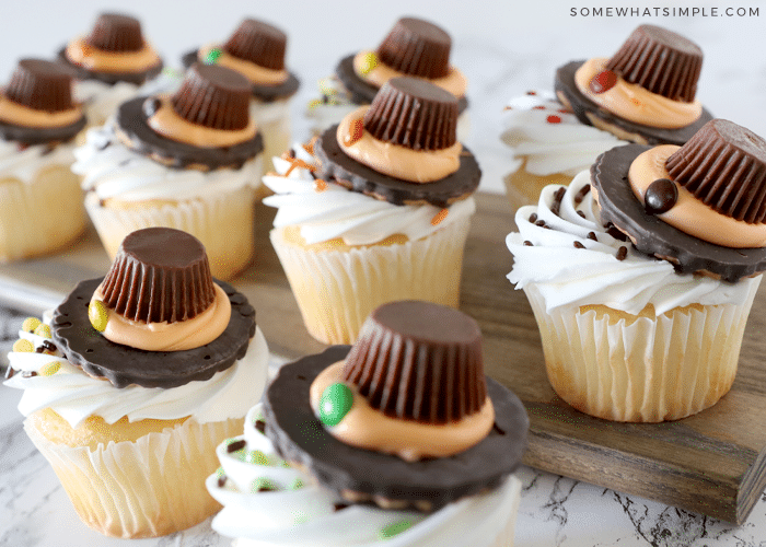 several pilgrim hat cookies on top of cupcakes on the counter