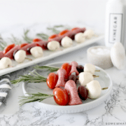 Caprese skewers on a white plate