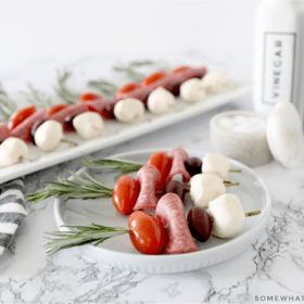 Caprese skewers on a white plate
