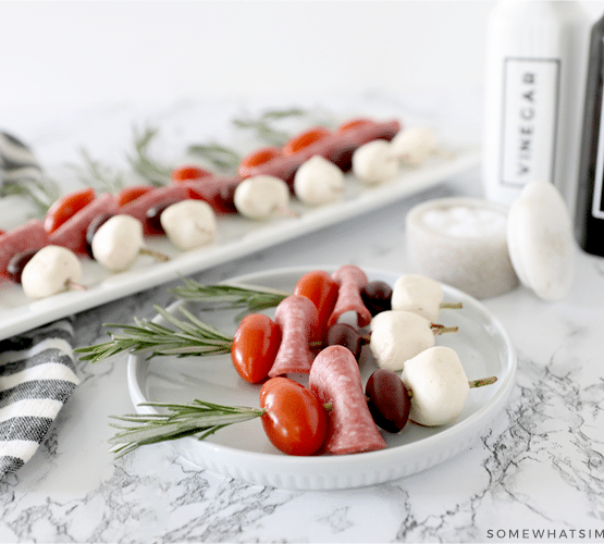 Caprese skewers on a white plate