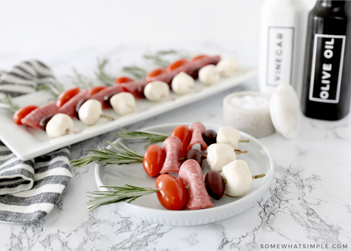 Caprese skewers on a white plate
