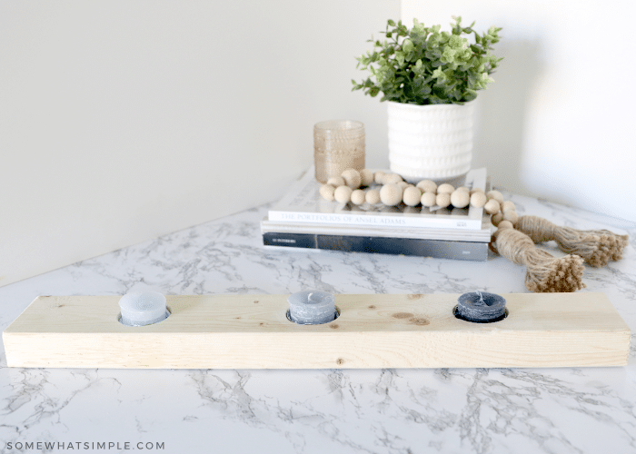 three candles in a wood Vented Frieze Board