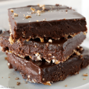 close up of a stack of brownie on a white plate