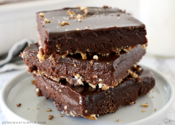 close up of a stack of brownie on a white plate