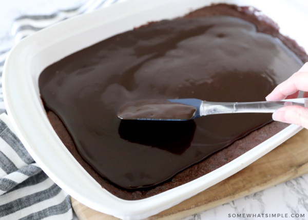 spreading ganache over brownies