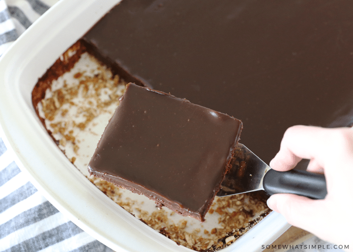 serving fudge brownies from a baking dish