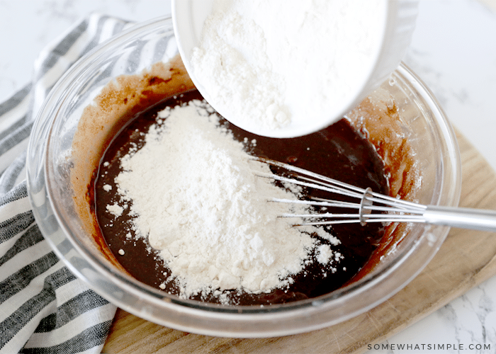 mixing chocolate brownie mix in a glass bowl