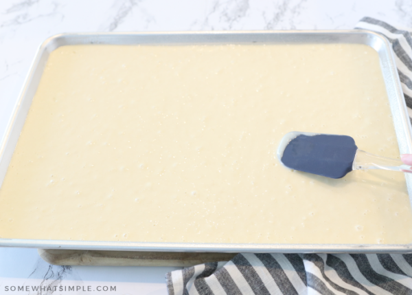 spreading pancake batter into a sheet pan