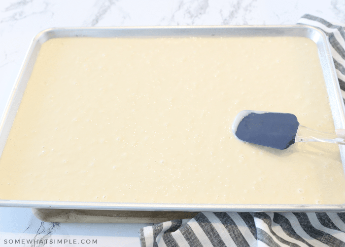 spreading pancake batter into a sheet pan