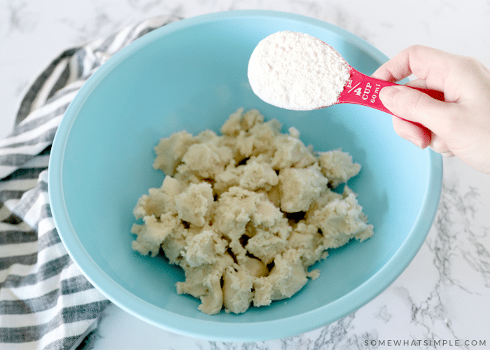 blue bowl with sugqr cookie dough