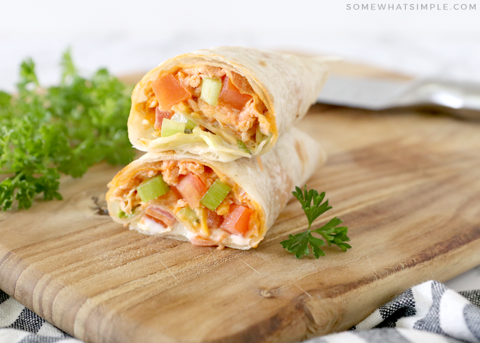 buffalo chicken wraps on a wood cutting board