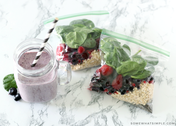 smoothie packets on a counter with a finished smoothie