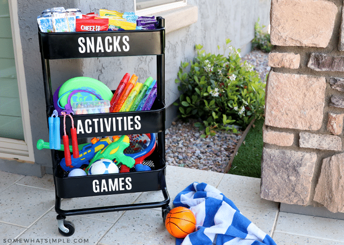 black cart with games and snacks for kids to play outside