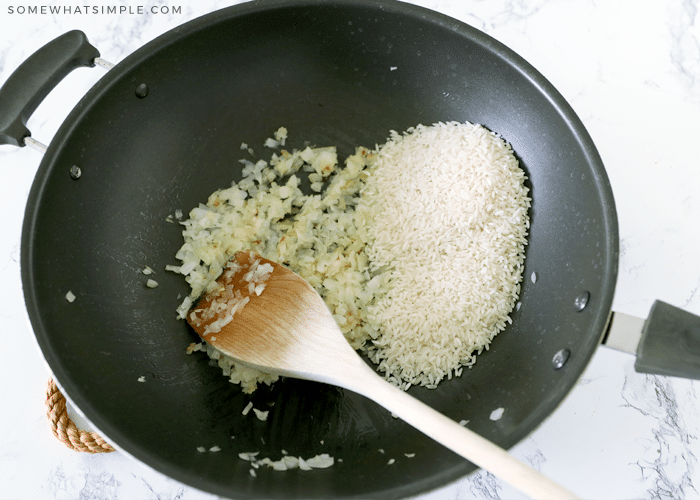 rice and onion cooking in a pan