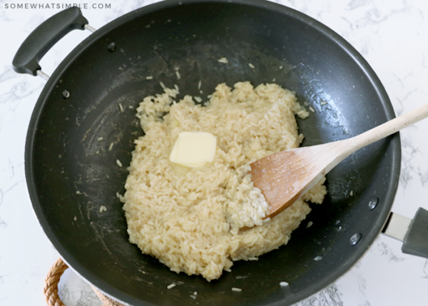 adding butter to cooked rice