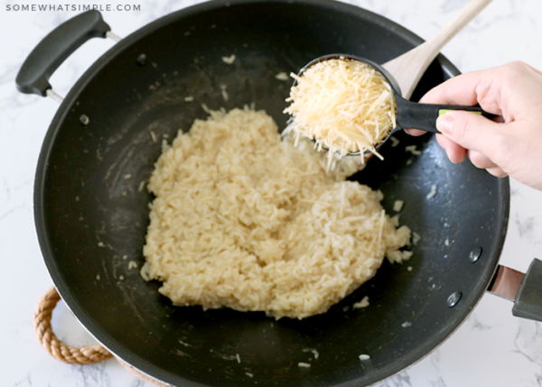 adding parmesan cheese to risotto