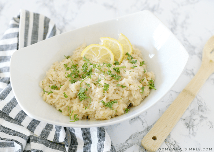 parmesan risotto with lemon slices in a white bowl