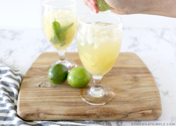 squeezing lime over a margarita