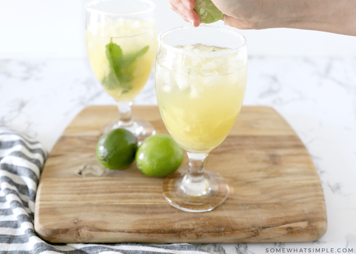 squeezing lime over a margarita