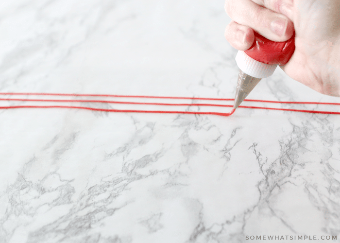 piping lines on wax paper to make sprinkles